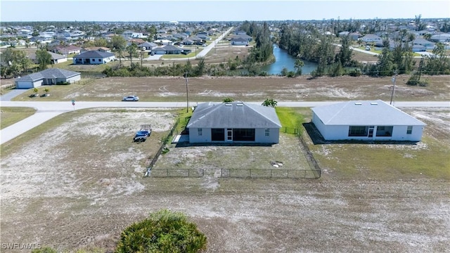 birds eye view of property with a residential view and a water view