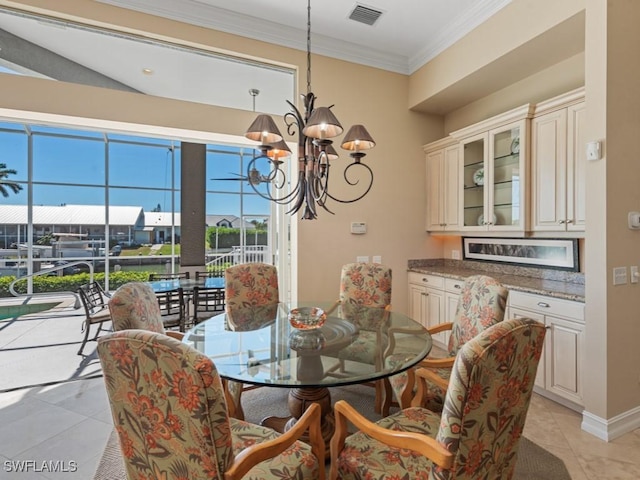 dining area with light tile patterned floors, visible vents, a chandelier, and crown molding