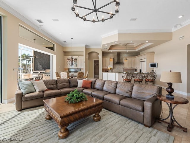 living area featuring recessed lighting, a tray ceiling, arched walkways, and crown molding