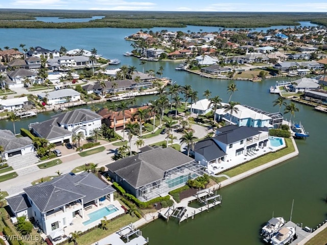 drone / aerial view featuring a residential view and a water view