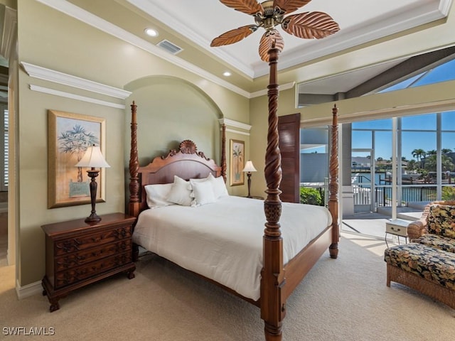 bedroom featuring a tray ceiling, access to outside, visible vents, and carpet floors