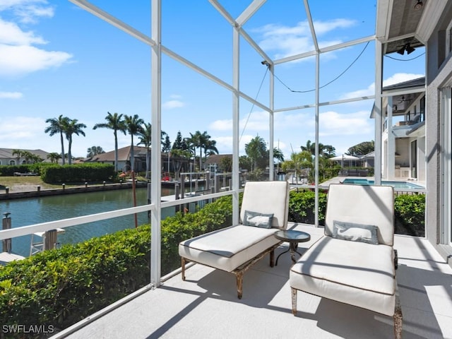 sunroom / solarium with a water view