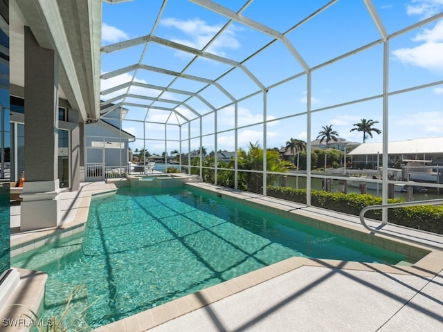 view of swimming pool featuring a patio area, glass enclosure, and a pool with connected hot tub