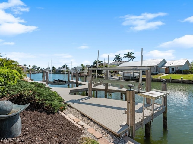 dock area with a water view and boat lift