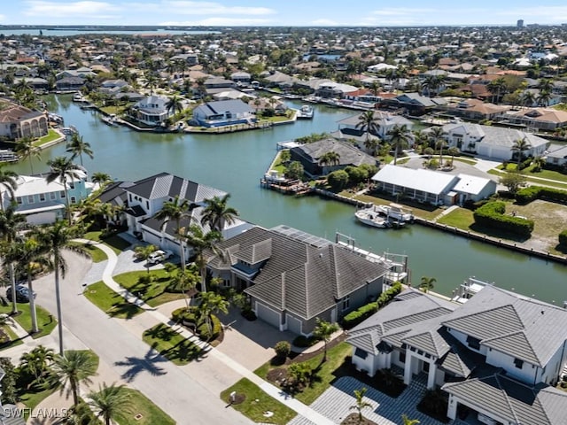 drone / aerial view featuring a residential view and a water view