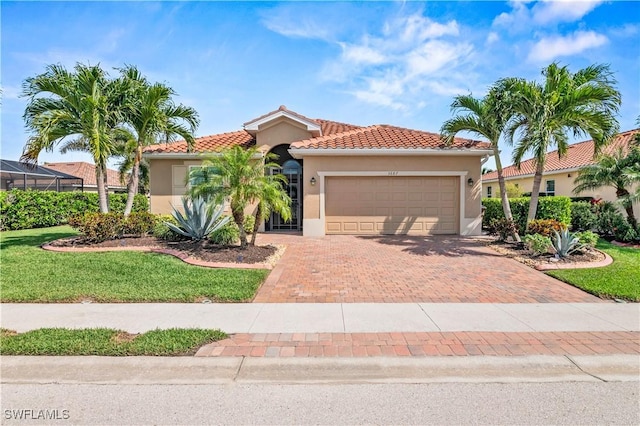 mediterranean / spanish home with a tiled roof, decorative driveway, a garage, and stucco siding