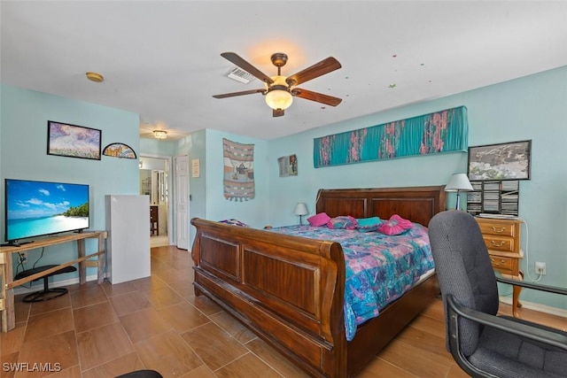 bedroom with visible vents, baseboards, and ceiling fan