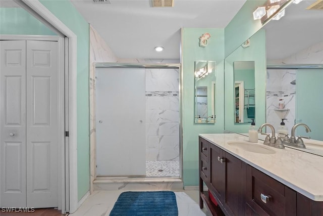 full bathroom featuring visible vents, a stall shower, a closet, marble finish floor, and vanity