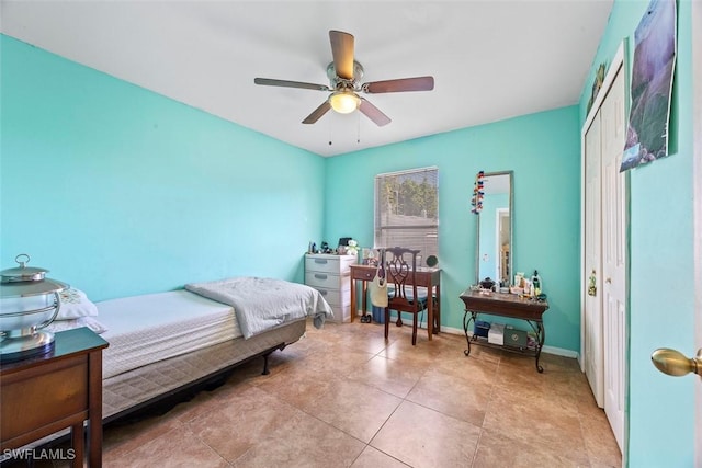 bedroom with light tile patterned floors, ceiling fan, and baseboards