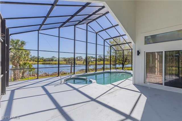 view of pool with a patio area, glass enclosure, a pool with connected hot tub, and a water view