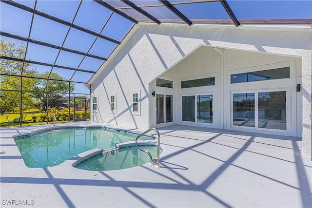 view of swimming pool with a lanai, a pool with connected hot tub, and a patio