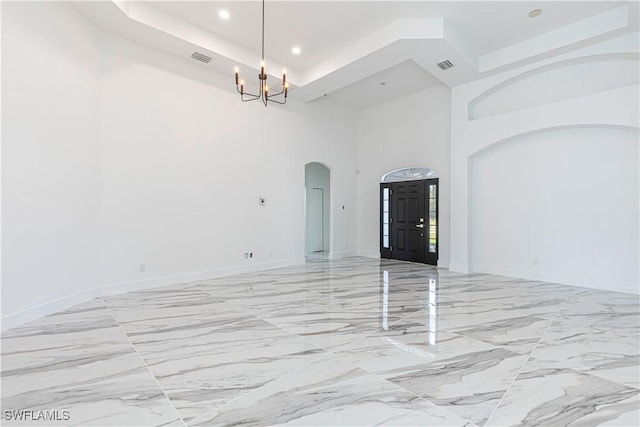 empty room featuring visible vents, baseboards, an inviting chandelier, recessed lighting, and arched walkways