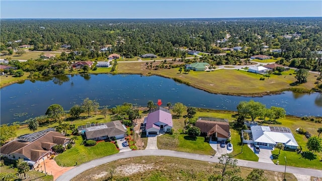 bird's eye view with a wooded view, a water view, and a residential view