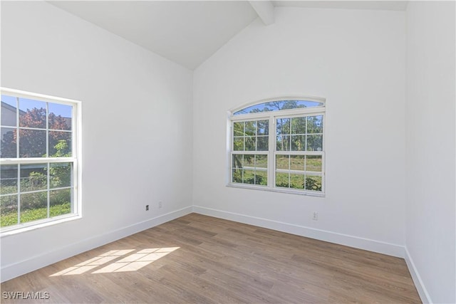 unfurnished room featuring beamed ceiling, high vaulted ceiling, baseboards, and wood finished floors