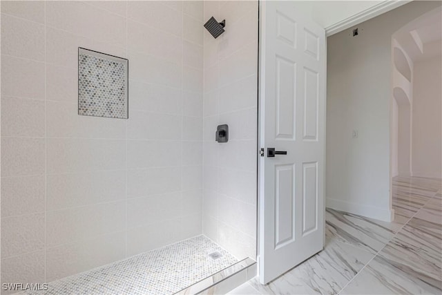 full bathroom with baseboards, marble finish floor, and tiled shower