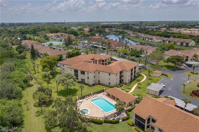 drone / aerial view featuring a residential view and a water view