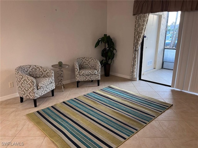 sitting room with tile patterned flooring and baseboards