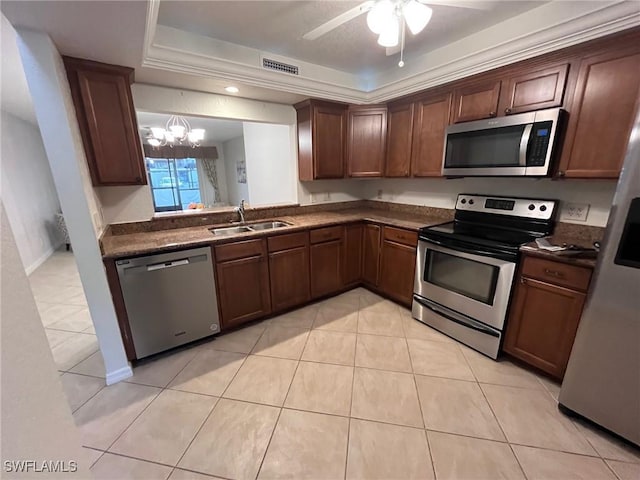 kitchen featuring dark countertops, visible vents, appliances with stainless steel finishes, and a sink