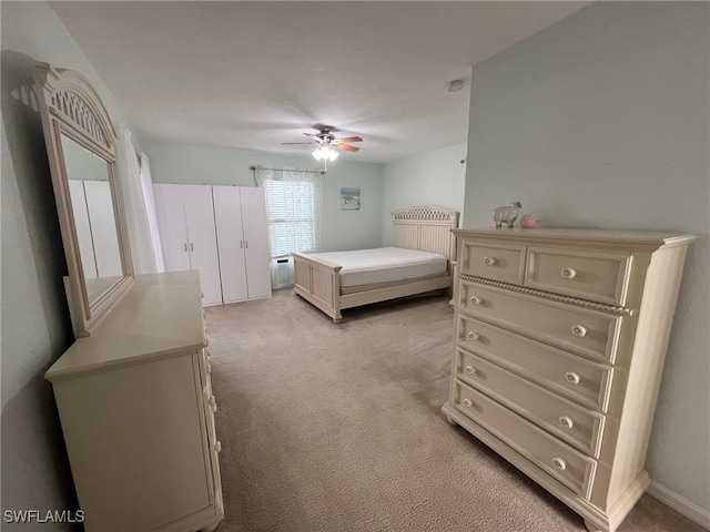 bedroom with light carpet and ceiling fan