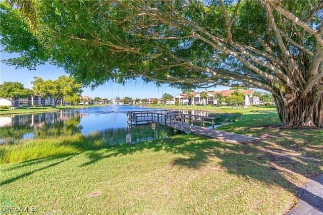 dock area featuring a yard and a water view