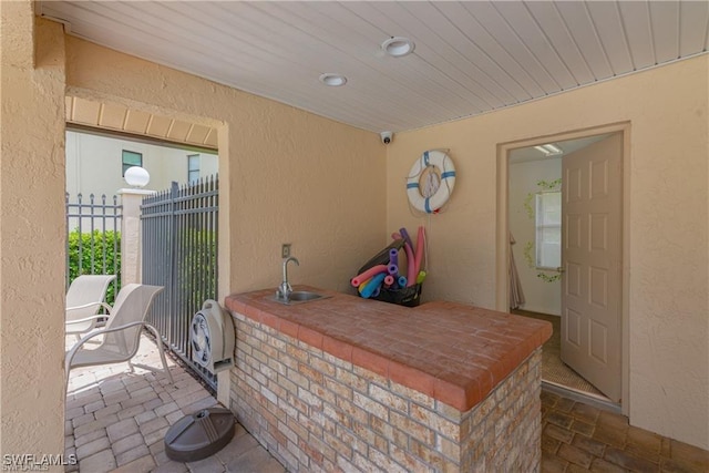 view of patio featuring a sink and fence