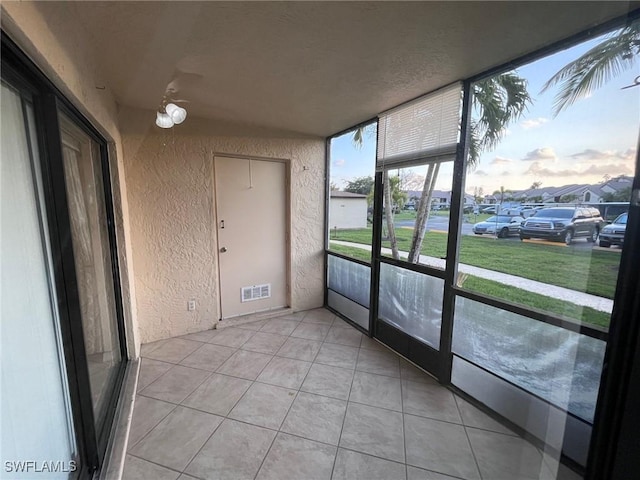 unfurnished sunroom featuring visible vents