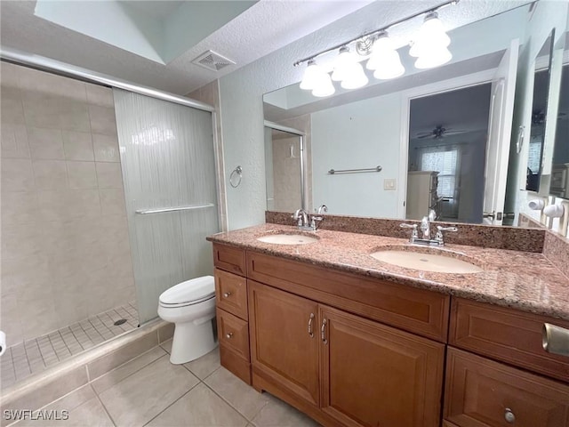 full bathroom with tile patterned flooring, visible vents, a stall shower, and a sink