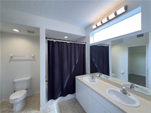 bathroom with tile patterned floors, toilet, visible vents, and a sink