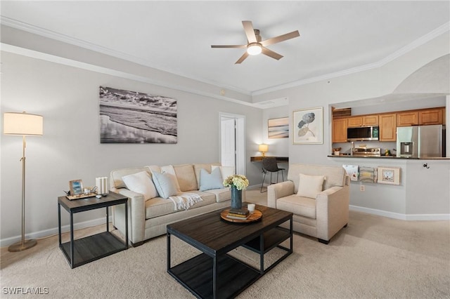 living room with crown molding, baseboards, light colored carpet, arched walkways, and a ceiling fan