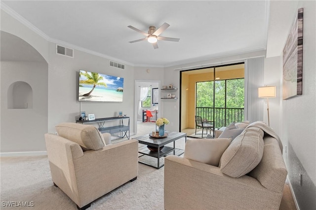 12965 Positano Cir Unit 304, Naples, FL 34105 - living area with a ceiling fan, arched walkways, light carpet, crown molding, and baseboards