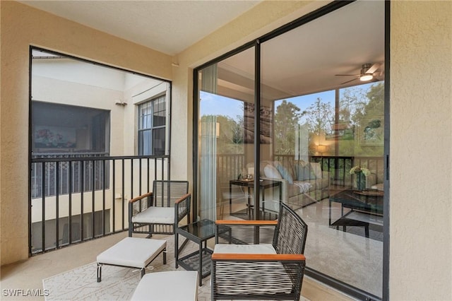 sunroom featuring a ceiling fan