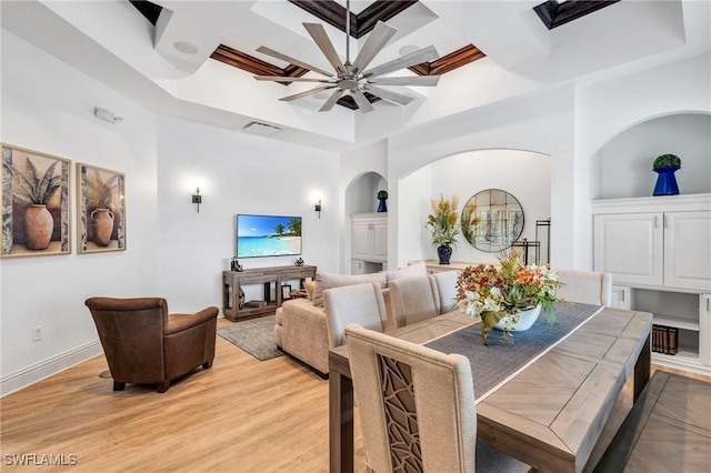 dining room with baseboards, visible vents, coffered ceiling, ceiling fan, and light wood-type flooring