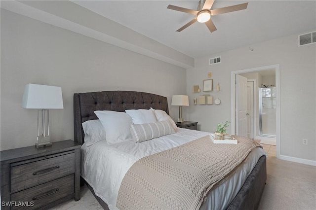 bedroom featuring visible vents, baseboards, light colored carpet, and ensuite bathroom