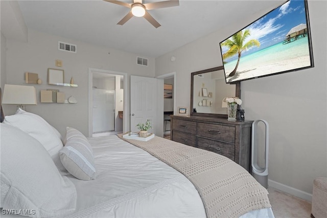 bedroom with connected bathroom, light colored carpet, visible vents, and baseboards