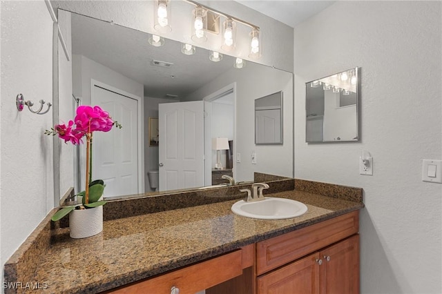 bathroom featuring vanity and visible vents