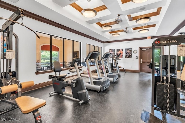 workout area featuring baseboards, coffered ceiling, and ornamental molding