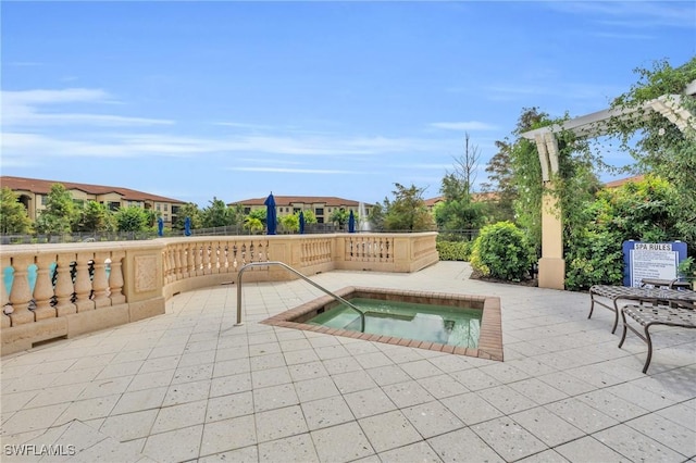 view of pool featuring a patio area and a hot tub