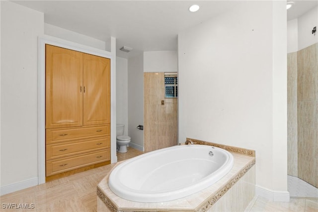 full bath featuring a garden tub, a tile shower, and toilet