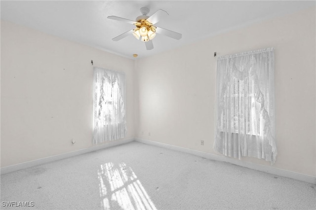 empty room with baseboards, carpet floors, and ceiling fan