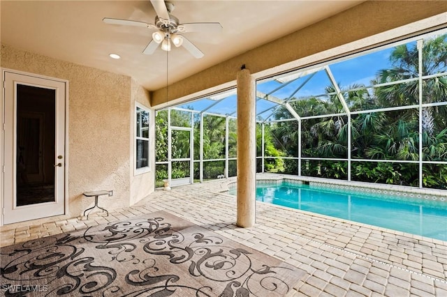 outdoor pool featuring a patio, a lanai, and ceiling fan