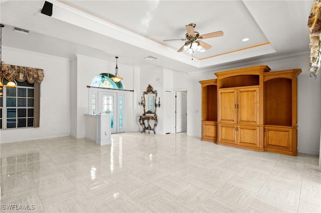 unfurnished room with visible vents, crown molding, a raised ceiling, and ceiling fan