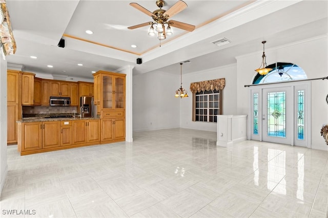 interior space with visible vents, a tray ceiling, recessed lighting, crown molding, and ceiling fan with notable chandelier