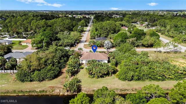 aerial view with a wooded view and a water view