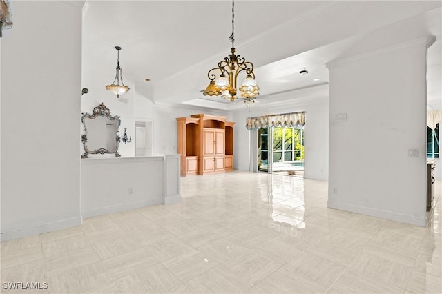 interior space featuring a tray ceiling, baseboards, and a notable chandelier