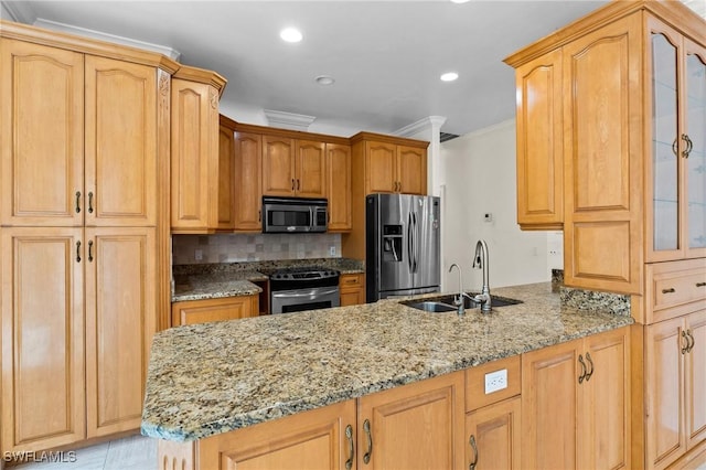 kitchen featuring light stone countertops, a peninsula, a sink, stainless steel appliances, and glass insert cabinets