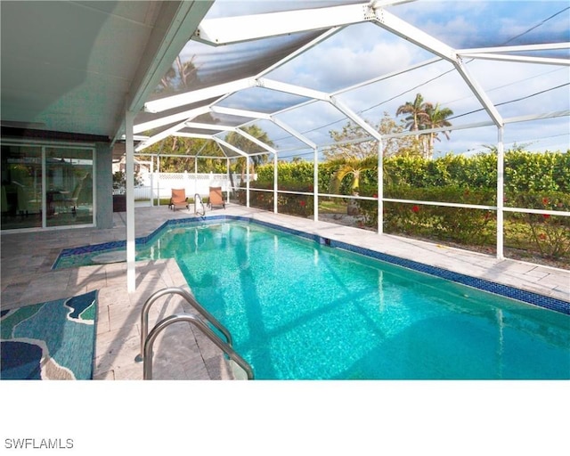 view of pool with a lanai, a fenced in pool, a patio, and fence