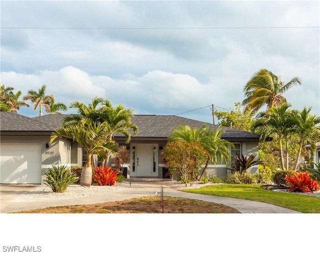 view of front of house with concrete driveway and an attached garage