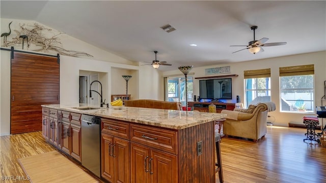 kitchen featuring dishwasher, a breakfast bar area, visible vents, and ceiling fan