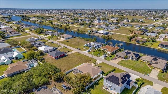 drone / aerial view featuring a residential view and a water view