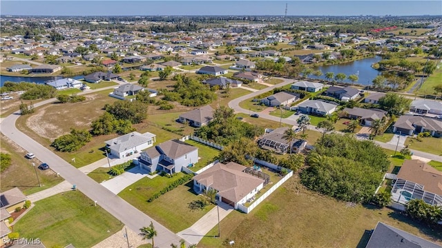 birds eye view of property with a residential view and a water view